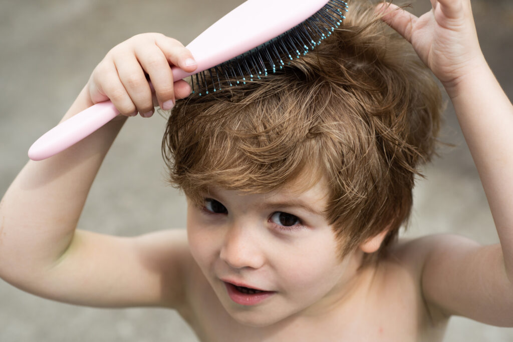 a boy brushing his hair