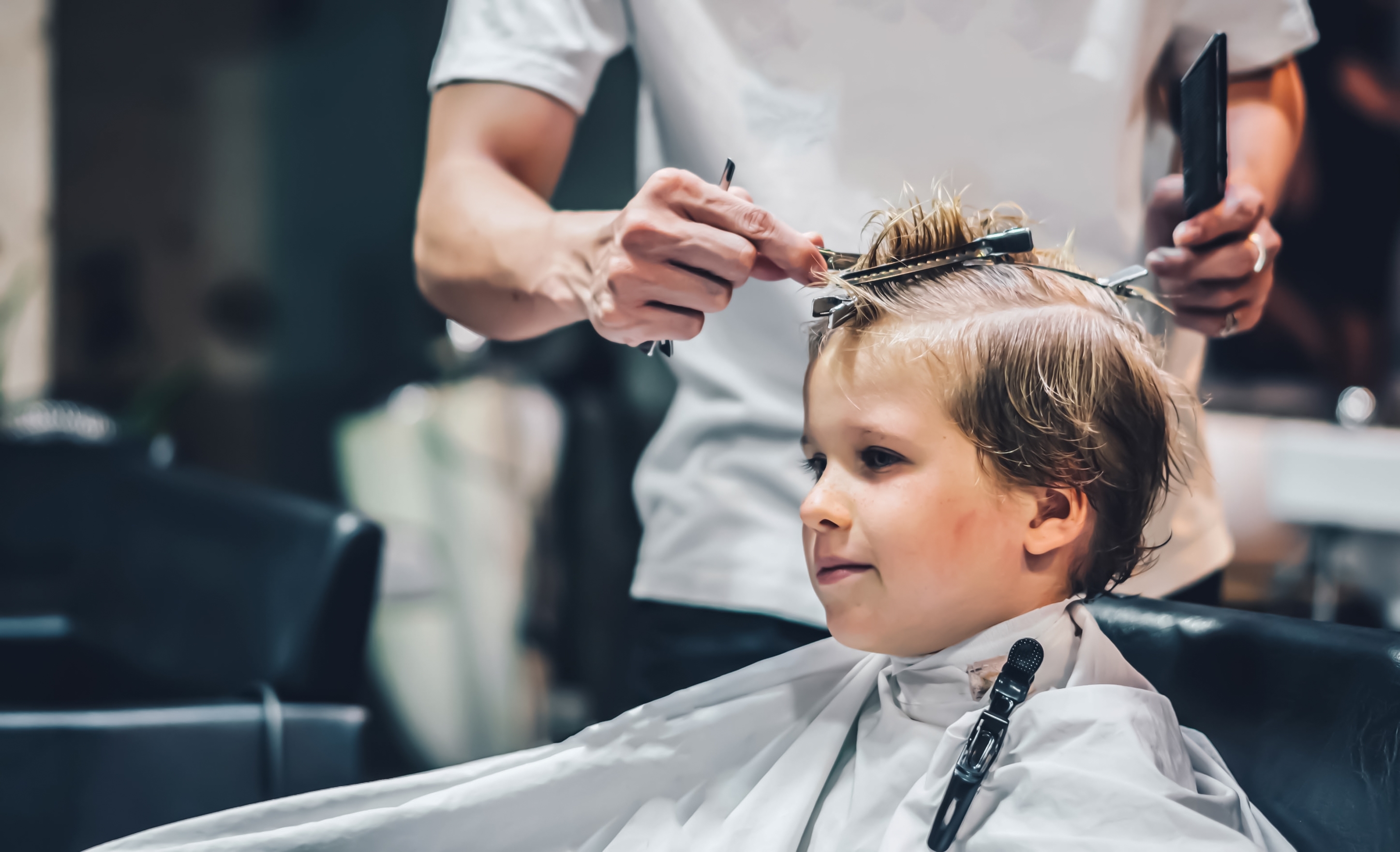 Barber consulting with client before haircut